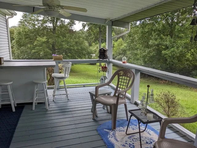 a view of a chairs and table in the balcony