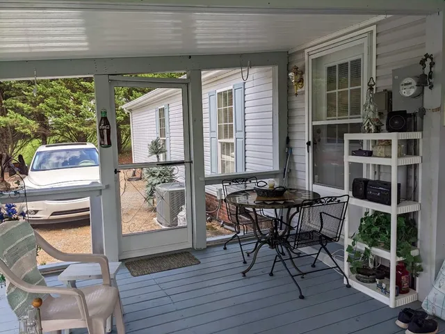 a view of a deck with table and chairs and wooden floor