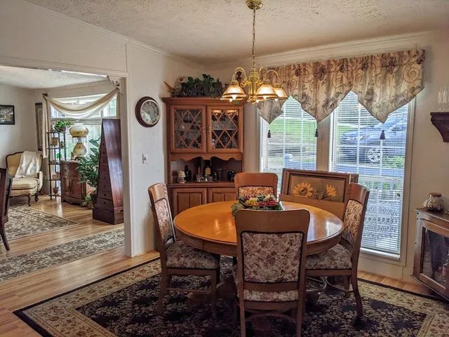 a view of a dining room with furniture and window