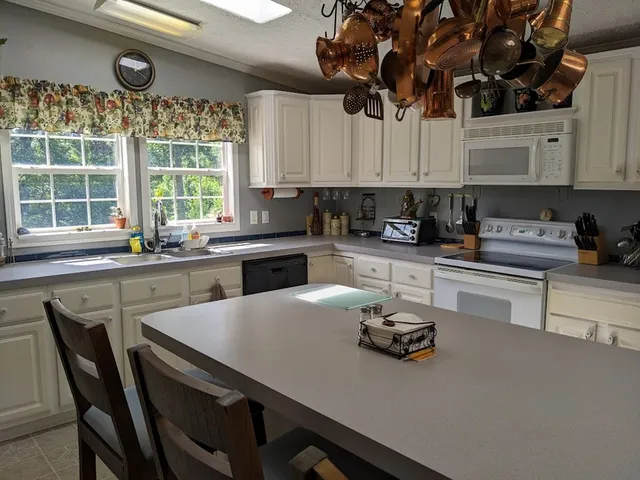 a kitchen with a table chairs stove and cabinets