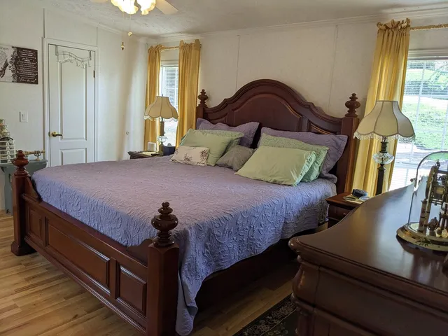 a bedroom with bed and window