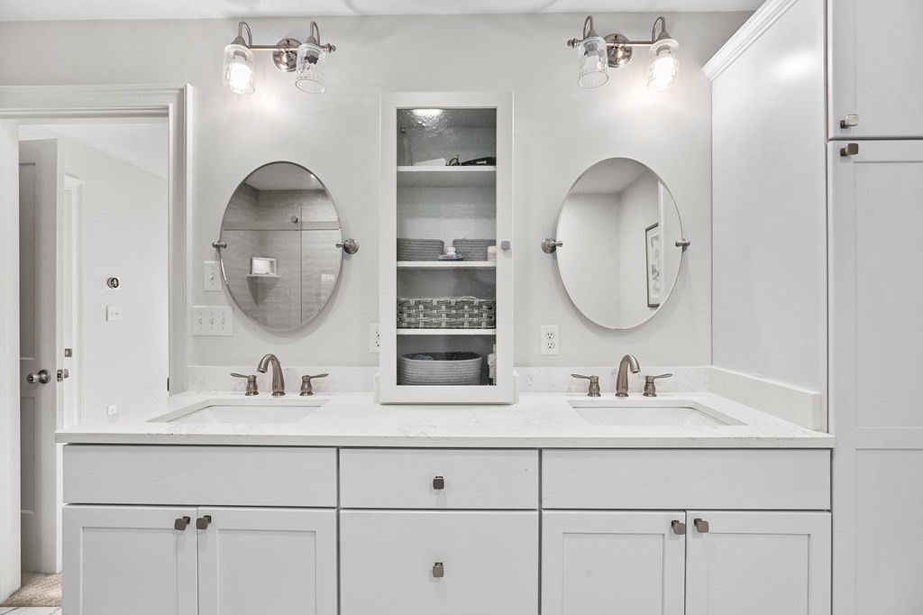 455 Broadway Hanover, MA 02339 - Photo 13 of 26 a bathroom with double vanity sinks and a mirror