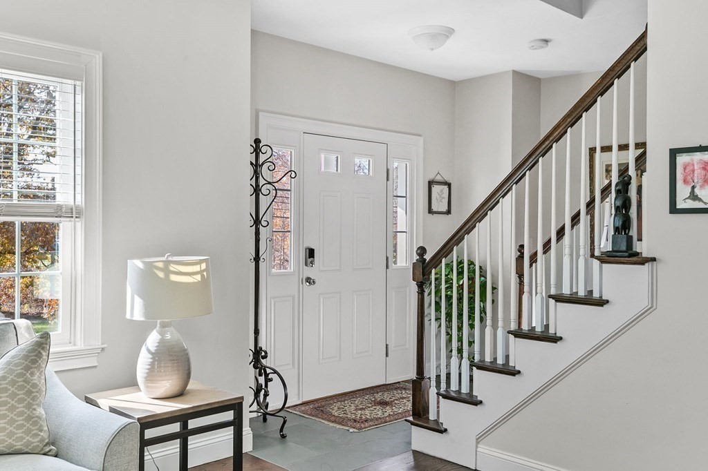 455 Broadway Hanover, MA 02339 - Photo 4 of 26 a view of entryway with wooden floor and stairs