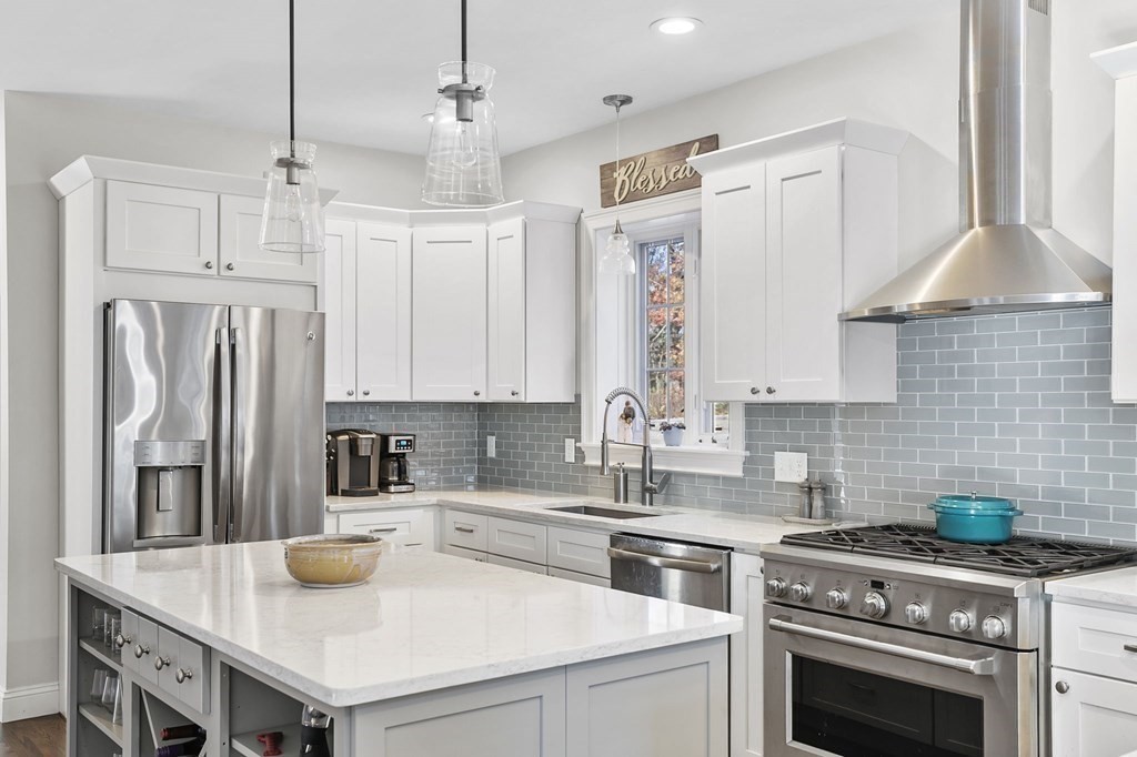 455 Broadway Hanover, MA 02339 - Photo 8 of 26 a kitchen with stainless steel appliances granite countertop a sink a stove and a refrigerator