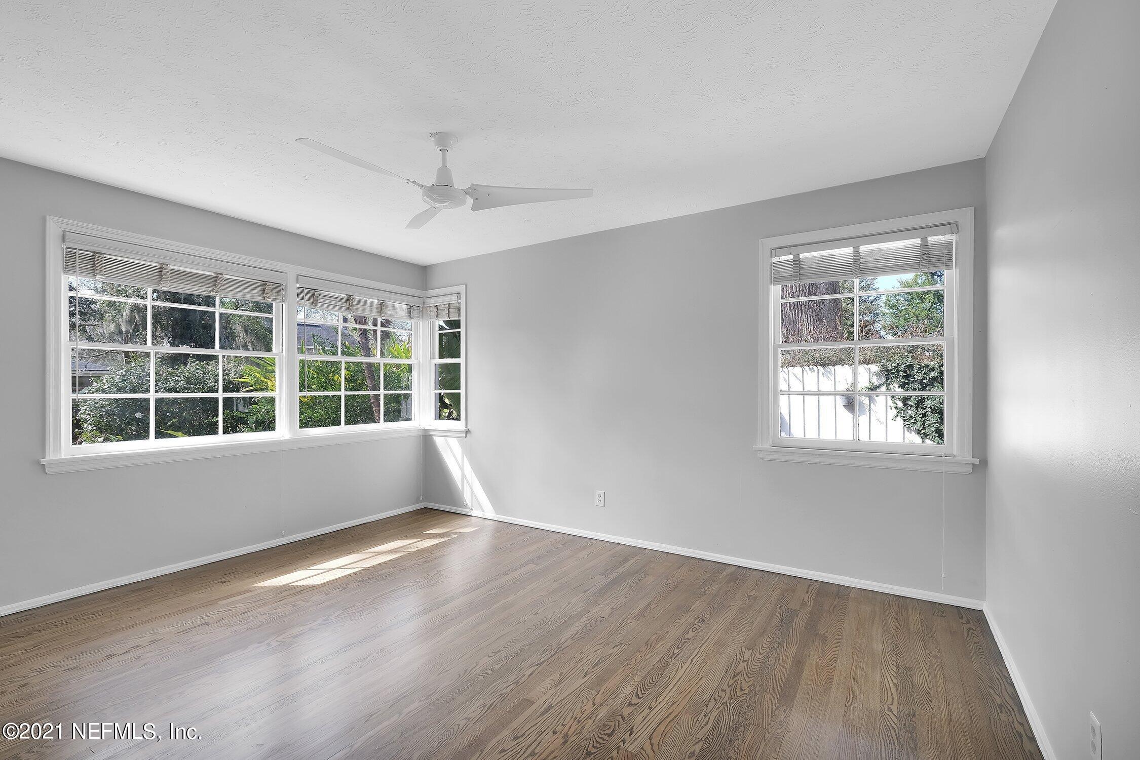 1614 Dunsford Road Jacksonville, FL 32207 - Photo 15 of 24 an empty room with wooden floor and windows