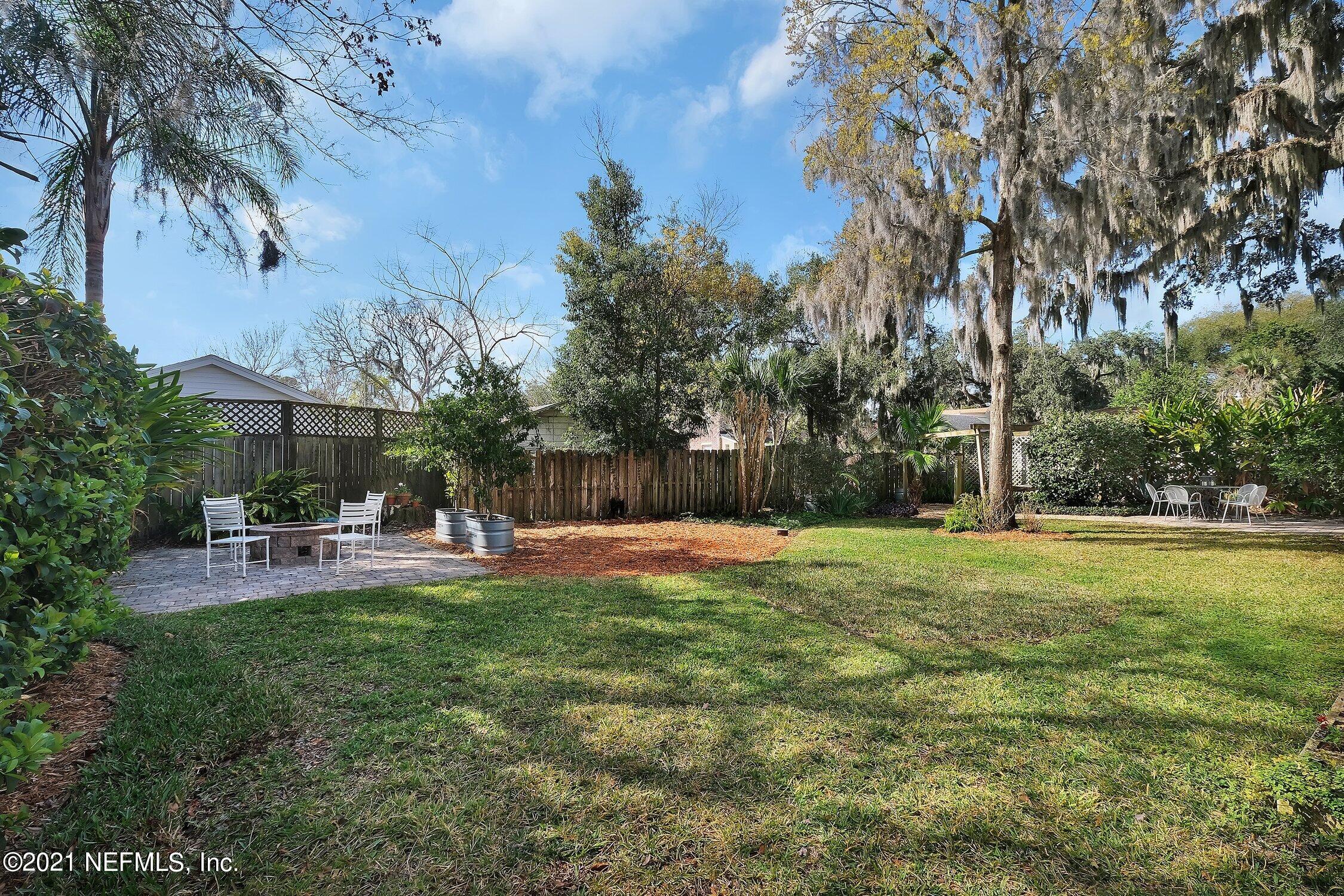 1614 Dunsford Road Jacksonville, FL 32207 - Photo 20 of 24 a view of a backyard with table and chairs and potted plants and large trees