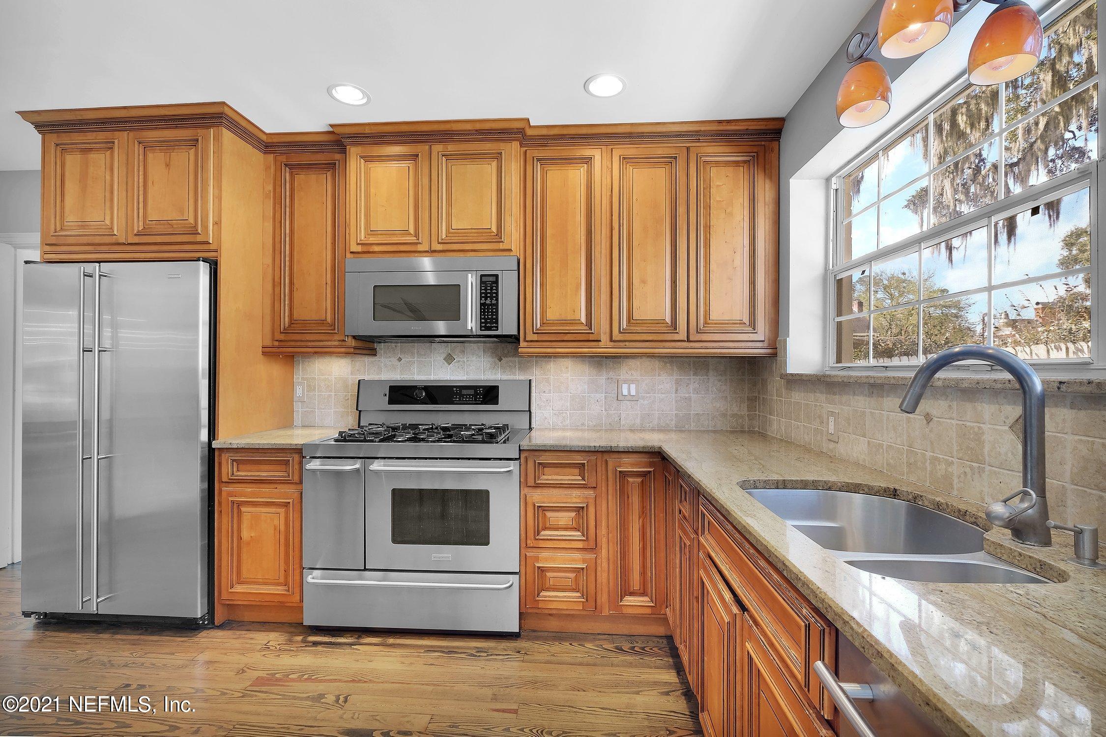 1614 Dunsford Road Jacksonville, FL 32207 - Photo 9 of 24 a kitchen with stainless steel appliances granite countertop a stove a sink and a microwave