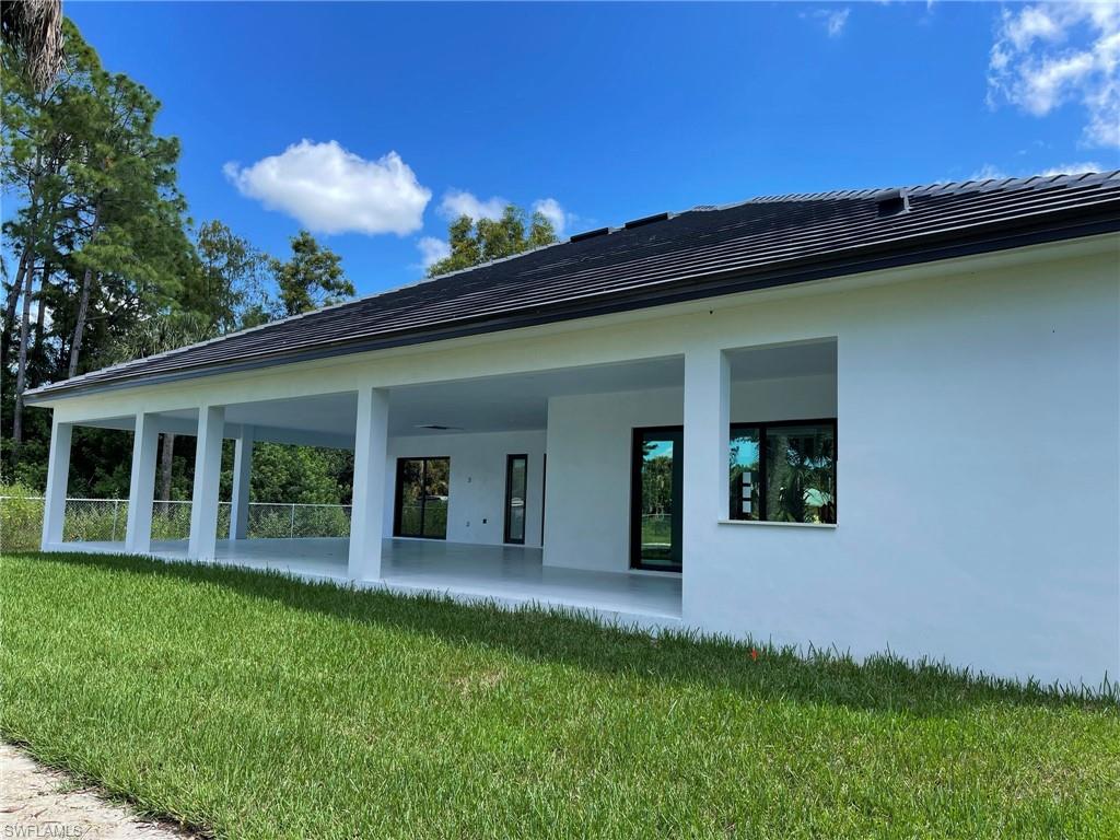 3203 68th Street Southwest Naples, FL 34105 - Photo 33 of 34 a view of a house with a backyard