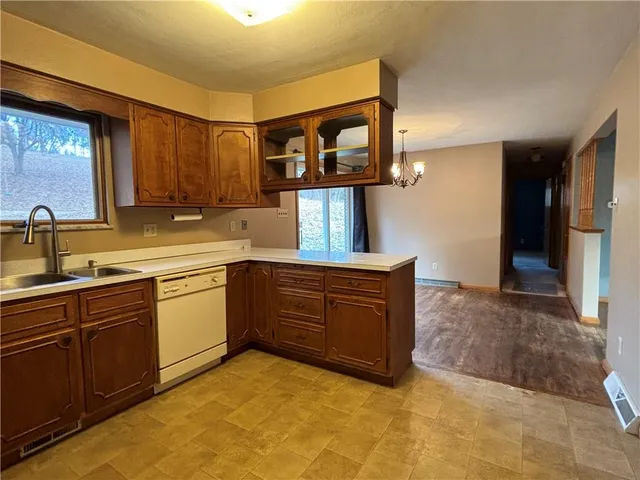 an empty room with a window and a ceiling fan