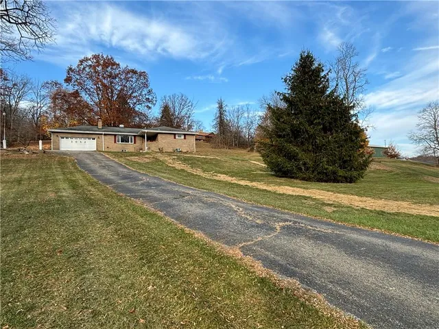 a backyard of a house with large trees