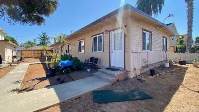a view of a house with backyard and sitting area