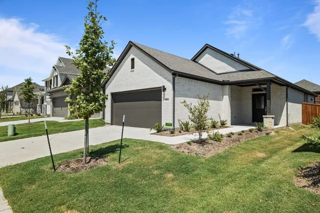 a view of a house with a yard and sitting area