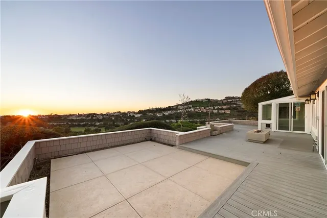 a view of roof deck with couches and sky view