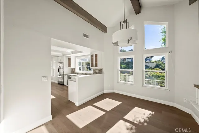 a kitchen with white cabinets and sink