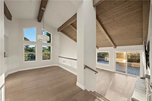 a view of an empty room with a fireplace and a window