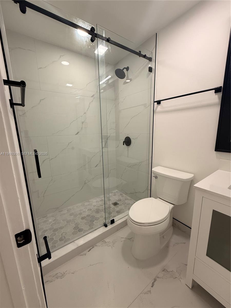 3666 Southwest 24th Terrace, Unit R Miami, FL 33145 - Photo 6 of 10 a bathroom with a toilet and a shower