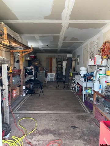 a view of a house with a big yard and large trees