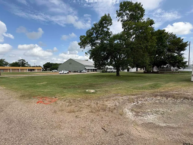a kitchen with a wooden floor and cabinets