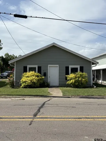 a kitchen with stainless steel appliances kitchen island granite countertop a refrigerator and cabinets