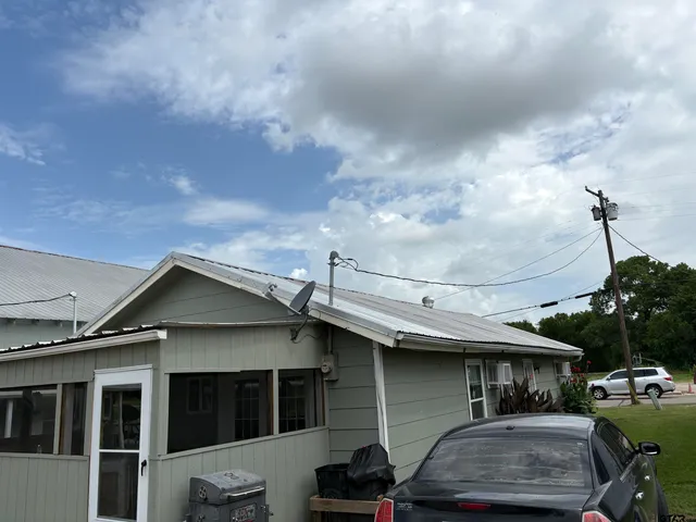 a living room with furniture a flat screen tv and kitchen view