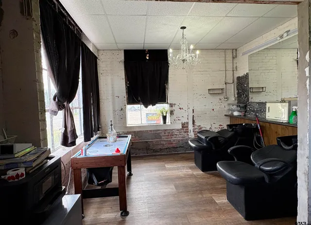 a living room with lots of furniture and clutter