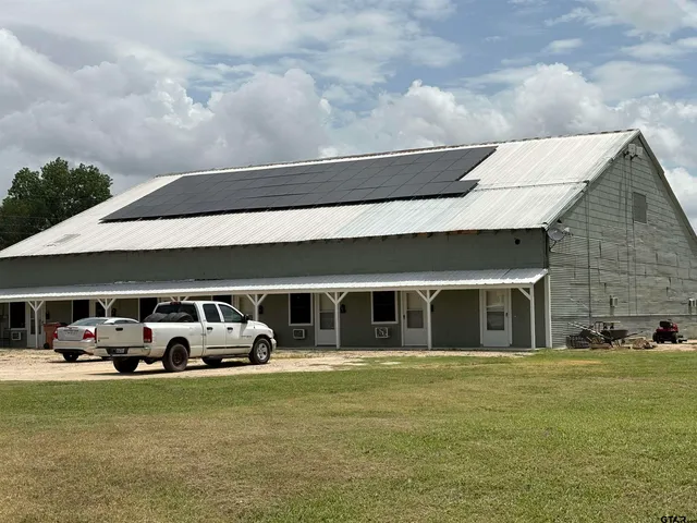a front view of building with cars parked