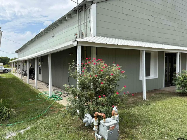 a front view of house and yard with seating space