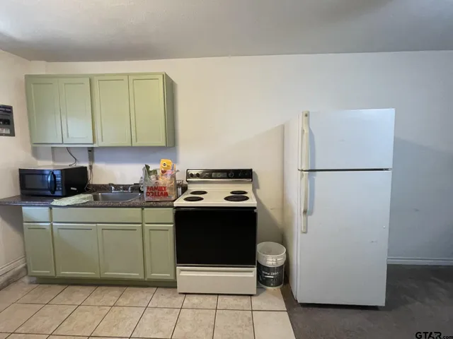 a kitchen with a refrigerator and a stove