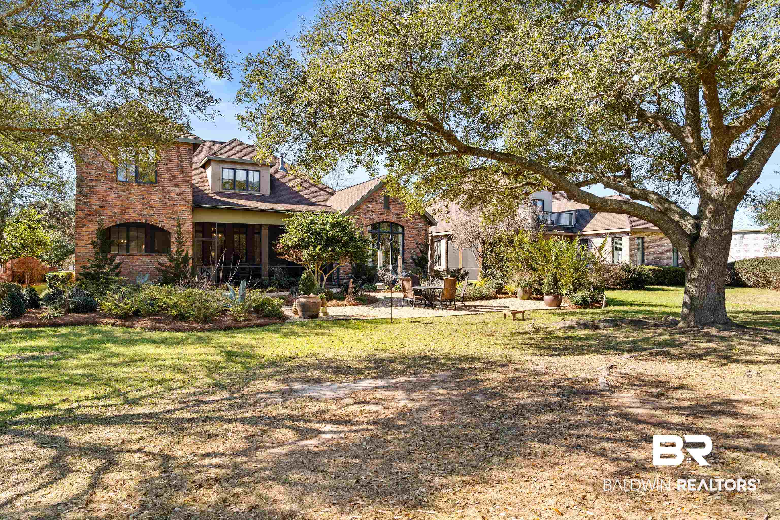 3613 Old Park Road Gulf Shores, AL 36542 - Photo 65 of 72 View of front of home featuring a front yard, a sunroom, brick siding, and a patio