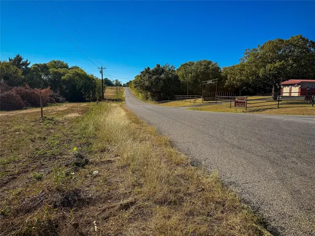 a view of a big yard with large trees