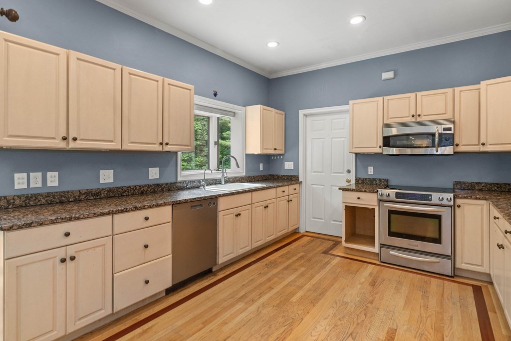 157 Spofford Road Boxford, MA 01921 - Photo 14 of 42 a kitchen with stainless steel appliances granite countertop a stove a sink and white cabinets