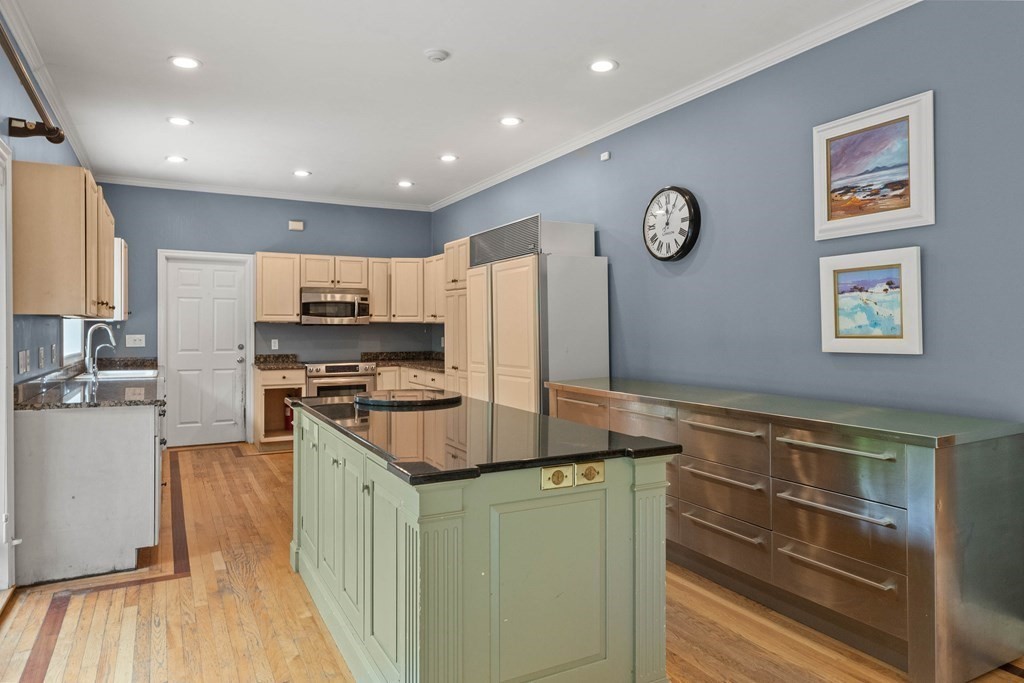 157 Spofford Road Boxford, MA 01921 - Photo 15 of 42 a kitchen with kitchen island granite countertop a stove cabinets and wooden floor