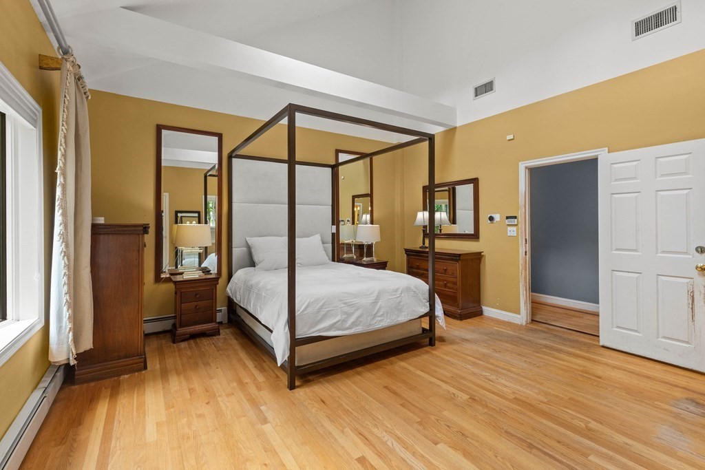 157 Spofford Road Boxford, MA 01921 - Photo 18 of 42 a bedroom with a bed and wooden floor