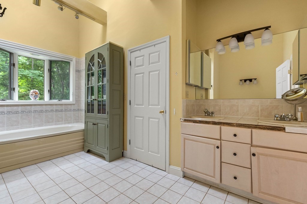 157 Spofford Road Boxford, MA 01921 - Photo 21 of 42 a spacious bathroom with a granite countertop sink a mirror and a bathtub