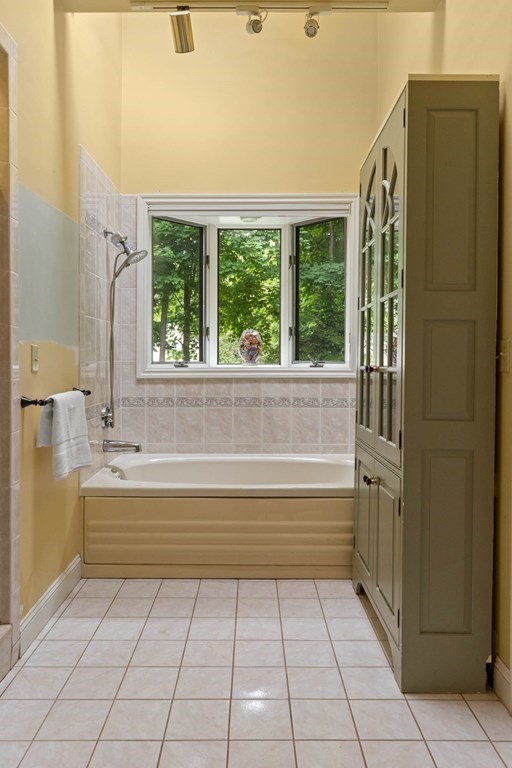 157 Spofford Road Boxford, MA 01921 - Photo 22 of 42 a bathroom with a bathtub and next to a window