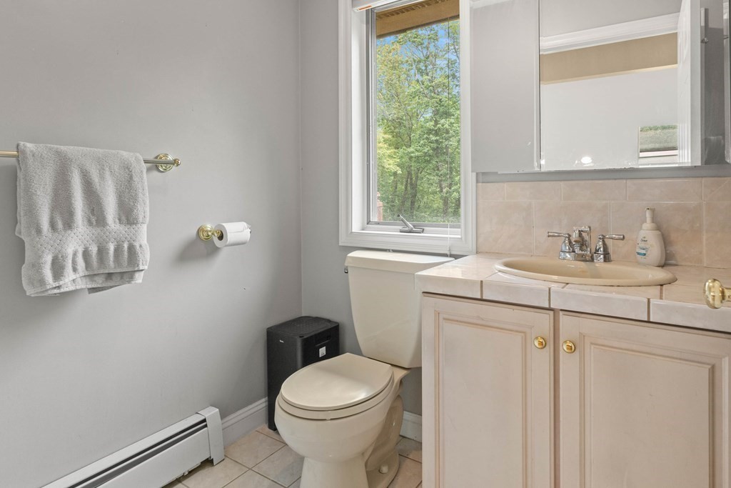 157 Spofford Road Boxford, MA 01921 - Photo 29 of 42 a bathroom with a sink a toilet and a window