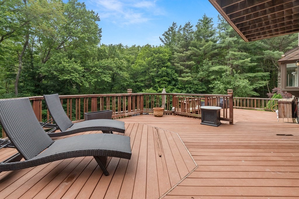 157 Spofford Road Boxford, MA 01921 - Photo 34 of 42 a view of a roof deck with table and chairs and wooden floor