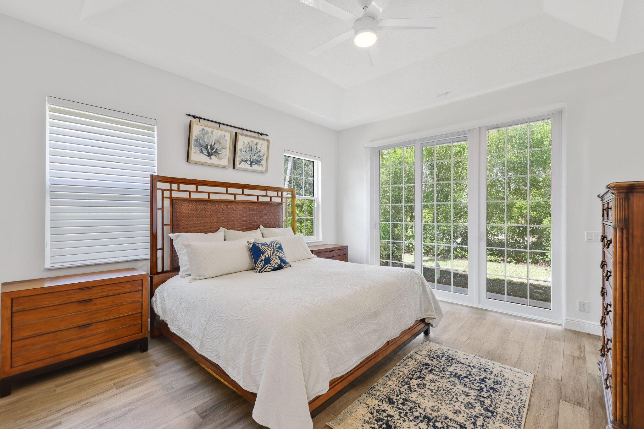 140 Mangrove Bay Way, Unit 140 Jupiter, FL 33477 - Photo 21 of 33 a bedroom with a bed and a window