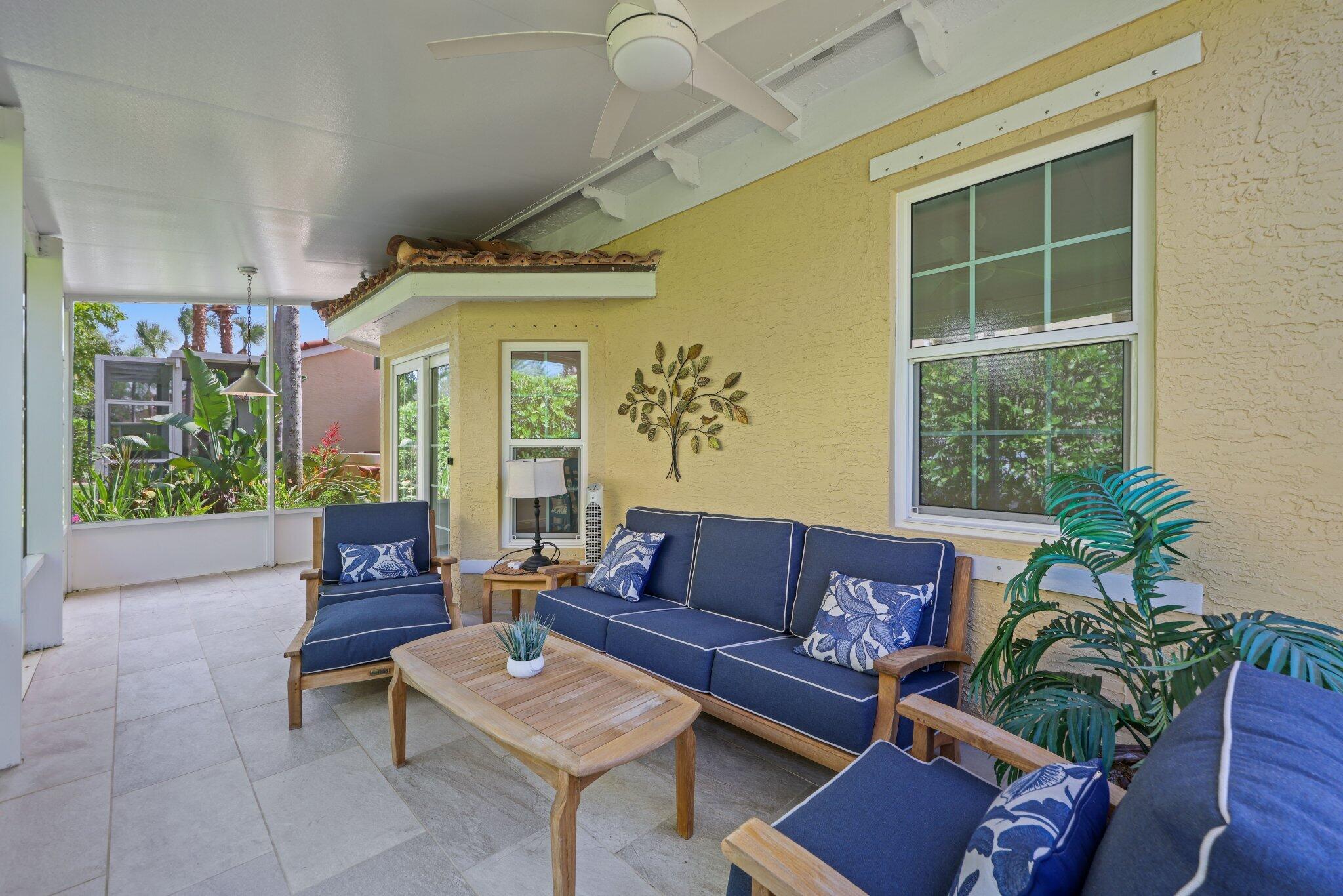 140 Mangrove Bay Way, Unit 140 Jupiter, FL 33477 - Photo 27 of 33 a living room with furniture and a large window