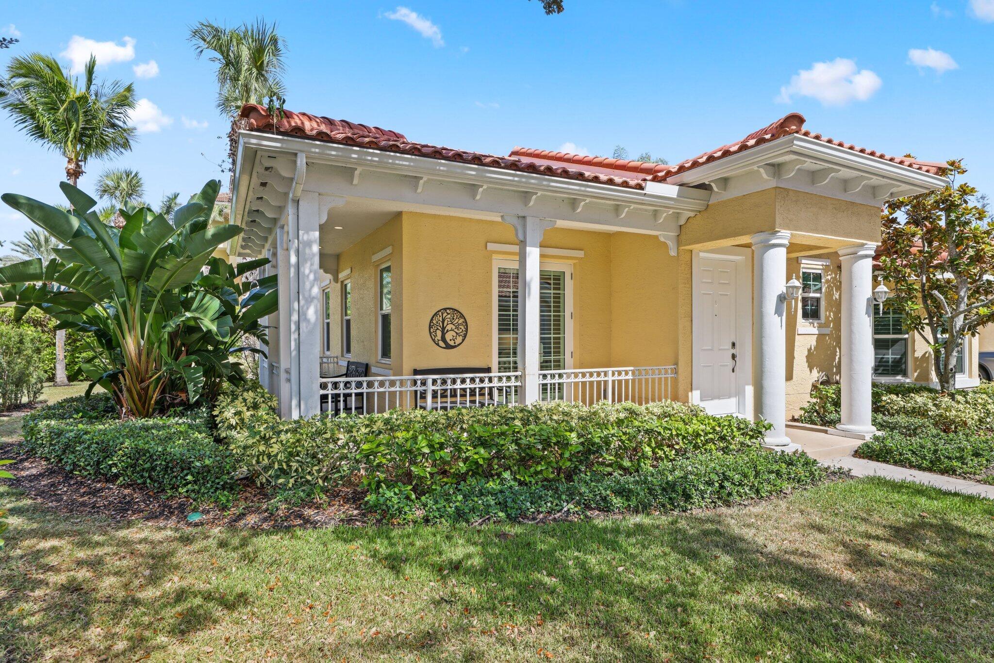 140 Mangrove Bay Way, Unit 140 Jupiter, FL 33477 - Photo 3 of 33 a front view of a house with a yard