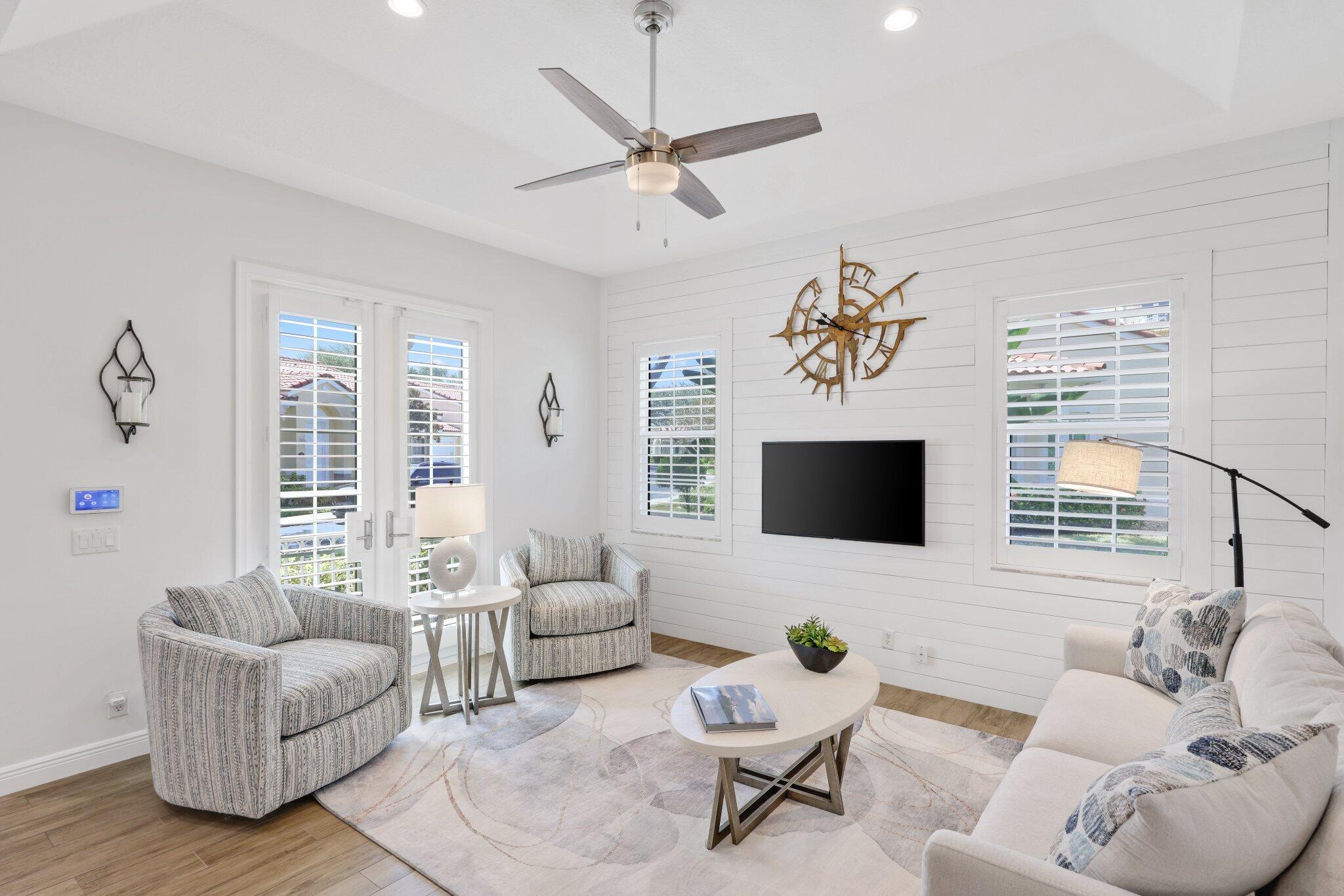 140 Mangrove Bay Way, Unit 140 Jupiter, FL 33477 - Photo 8 of 33 a living room with furniture and a flat screen tv