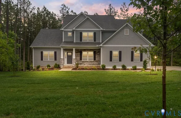 a front view of house with yard and green space