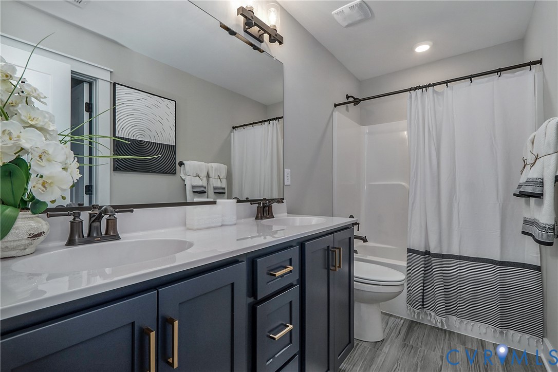 1 Scotchtown Road Beaverdam, VA 23015 - Photo 27 of 29 a bathroom with a granite countertop sink toilet a mirror a vanity and shower