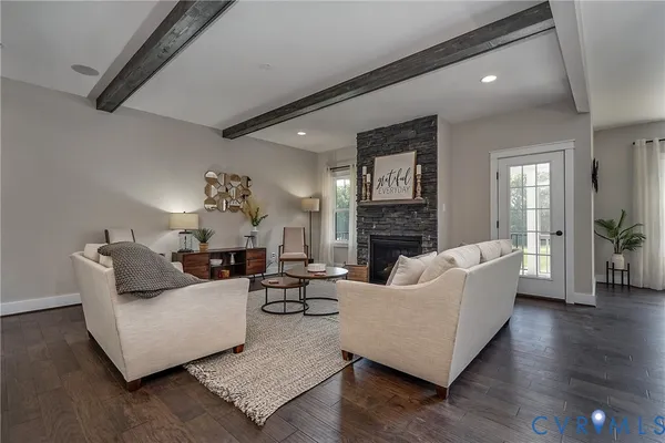 a living room with fireplace furniture and a wooden floor