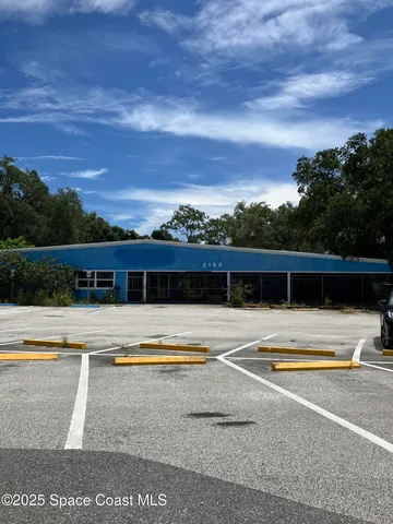 a view of swimming pool with outdoor seating and plants