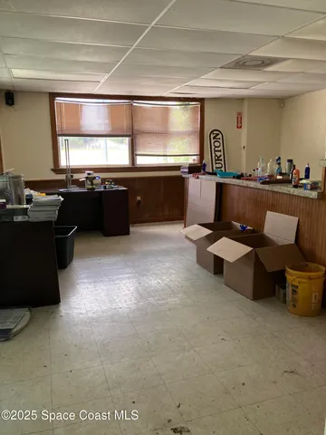 a living room with couches and chandelier