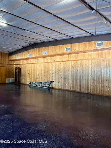 a view of a water heater room with wooden floor