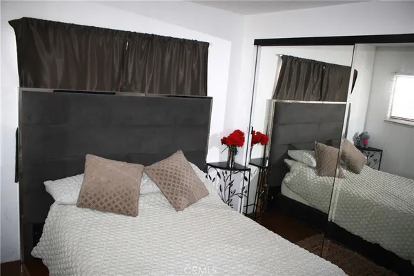 a bedroom with a bed and chair