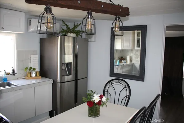 a kitchen with stainless steel appliances a stove a sink a microwave and cabinets