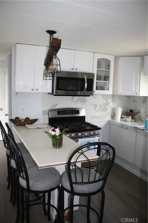 a kitchen with a stove a sink and a microwave